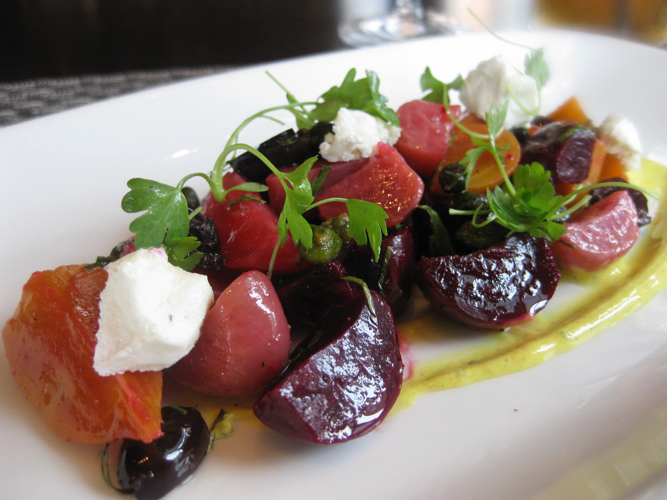 A plate of food with fruit and cheese on it.