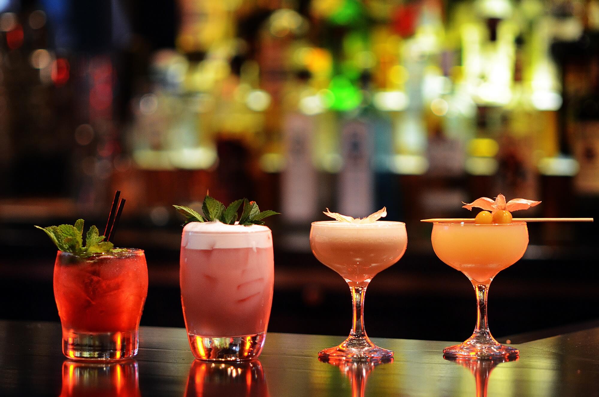 A bar with four different drinks on the table